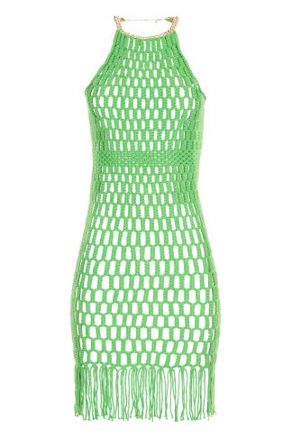 Vibrant green macramé dress with a fitted silhouette, featuring a geometric open-knit pattern and fringe detailing at the hem. The dress is accented with a gold necklace that also serves as a clasp at the neck, adding an elegant touch.