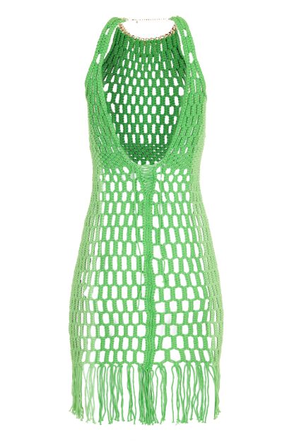 Vibrant green macramé dress with a fitted silhouette, featuring a geometric open-knit pattern and fringe detailing at the hem. The dress is accented with a gold necklace that also serves as a clasp at the neck, adding an elegant touch.