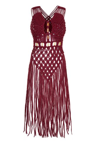 A handcrafted macramé dress in a deep burgundy color, featuring intricate knotted patterns, thin shoulder straps, and gold accents. The dress has a fitted bodice with detailed weaving, and long, fringed strands cascading down from the waist, creating a boho-chic aesthetic