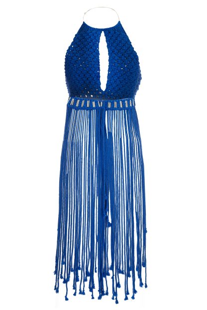 A striking blue macramé dress featuring a halter neckline with a teardrop cut-out at the chest. The dress is intricately woven with metallic accents at the waist and has long fringed strands that flow from the hips, adding a dynamic and elegant touch.