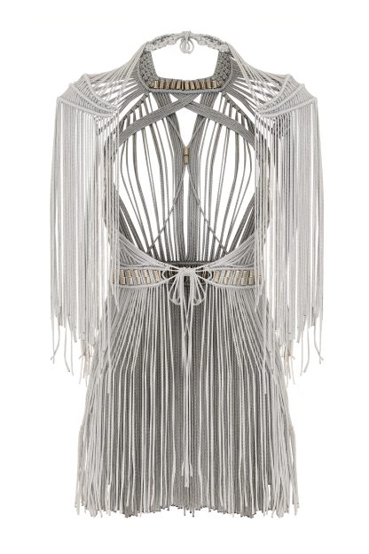 Close-up of a silver macramé dress with a flowing silhouette, featuring intricate bead detailing at the neckline and waist, and elegant fringes along the sleeves.