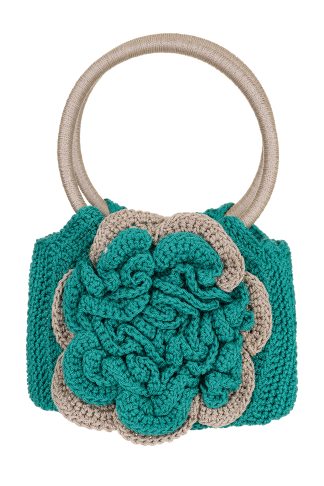 A handmade macramé handbag in green and beige, featuring a large front flower design and two round handles.