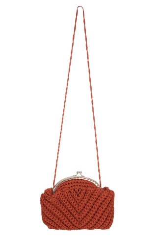 A handmade red-colored macramé handbag with a twisted strap and a silver metal clasp closure, featuring a detailed woven texture and a compact, rounded shape.