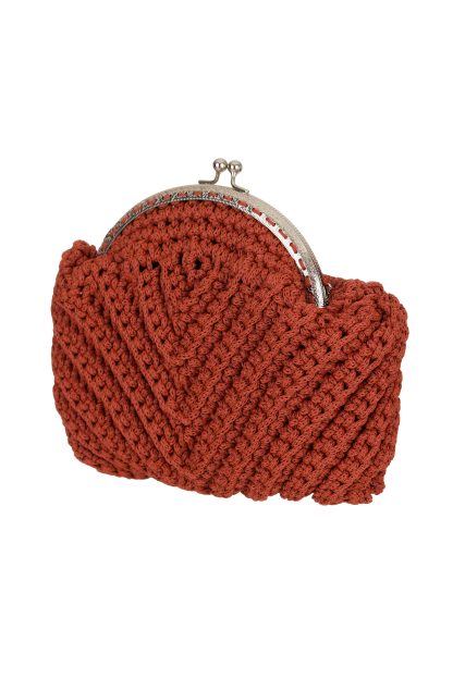 A handmade red-colored macramé handbag with a twisted strap and a silver metal clasp closure, featuring a detailed woven texture and a compact, rounded shape.