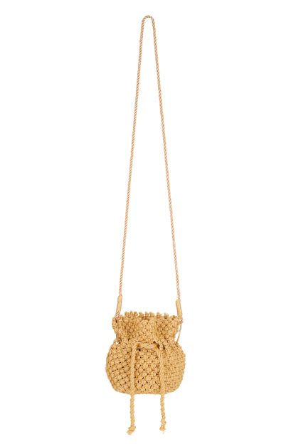 A handmade gold-colored macramé handbag with a drawstring closure, featuring a detailed woven texture and long twisted handles attached with golden rings.