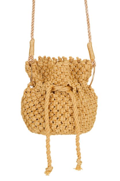 A handmade gold-colored macramé handbag with a drawstring closure, featuring a detailed woven texture and long twisted handles attached with golden rings.