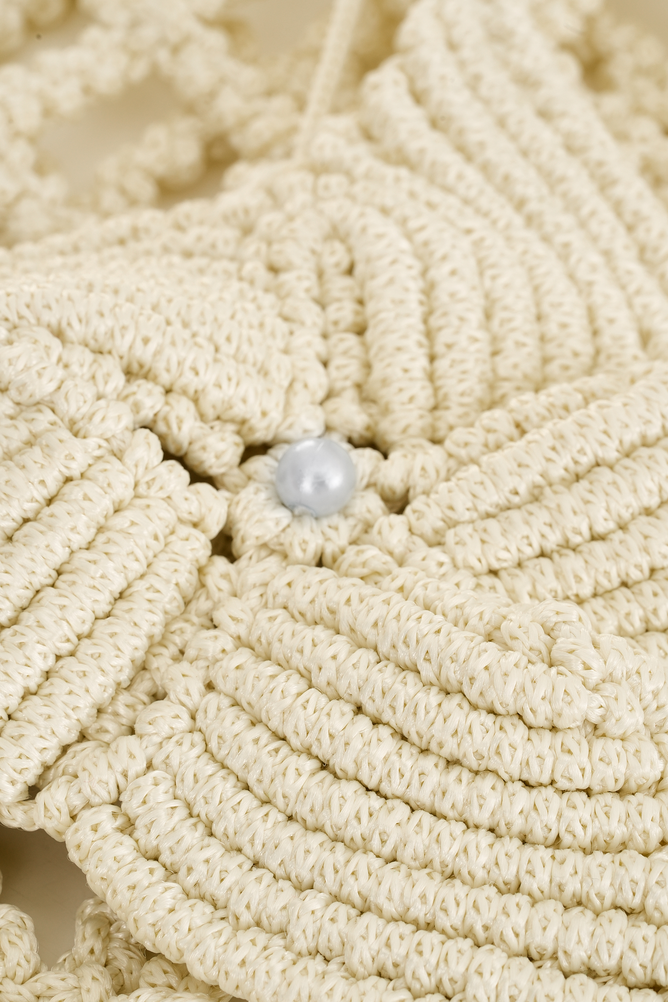 Close-up of starfish-shaped bustier on Mermaid’s Dreams Macramé Set, featuring delicate woven design and pearl accents.